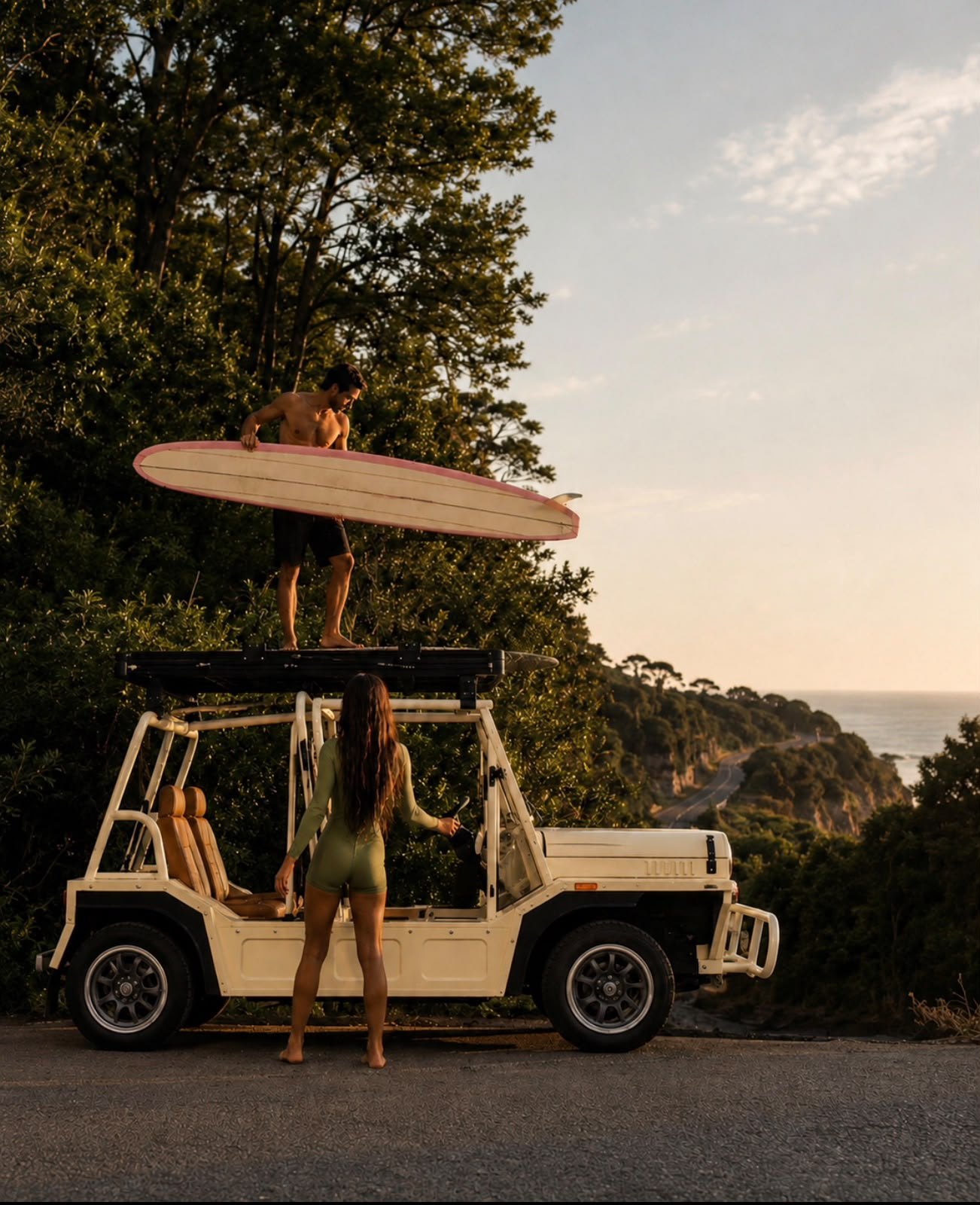 A couple loading a surfboard onto an Élan above the coast at sunset
